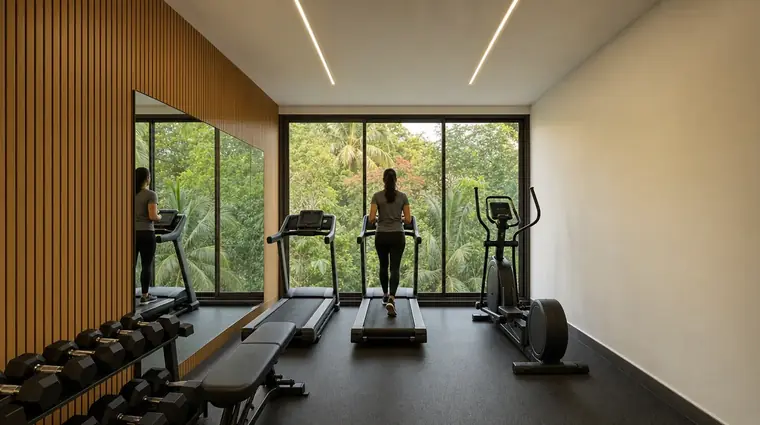 The first-floor fitness centre at North ONE, with treadmills facing full-height windows onto greenery