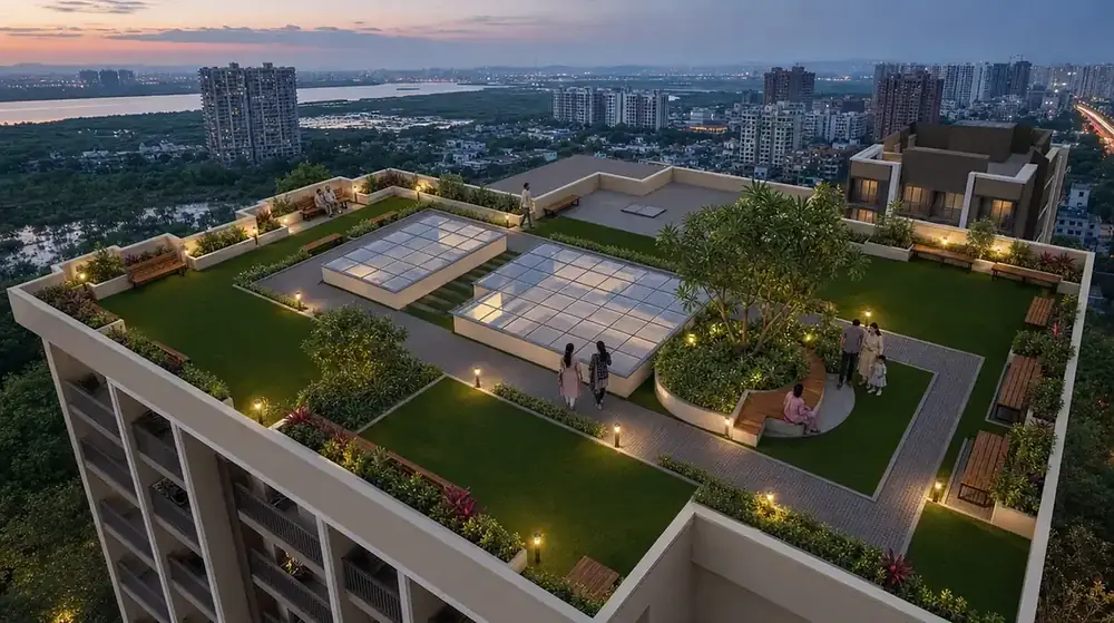 The landscaped roof garden at North ONE at dusk, with a perimeter jogging track, lawn and the Ulwe skyline beyond